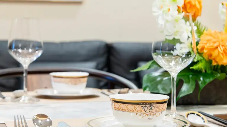 a table with plates and glasses on a table at YOKOHAMA STAY PREMIER in Yokohama
