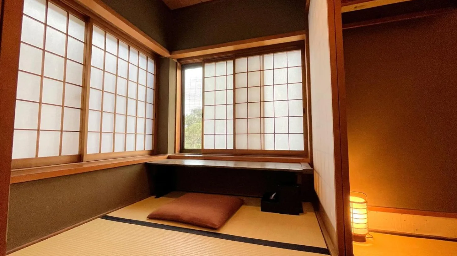 a room with two windows and a bed in it at Yuzuya Ryokan - Adult Only in Kyoto