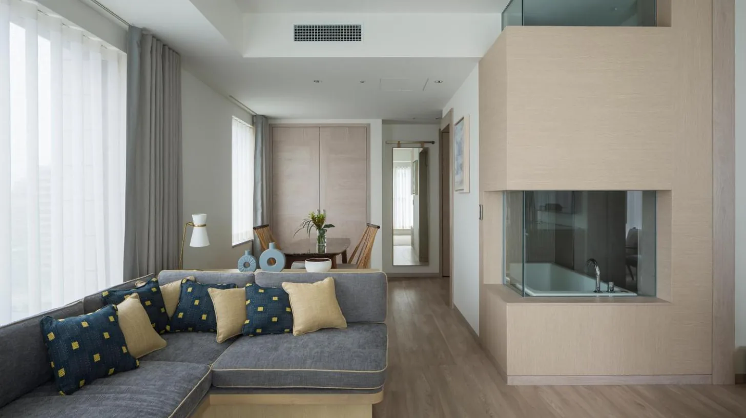 a living room with a couch and a television at Zentis Osaka in Osaka