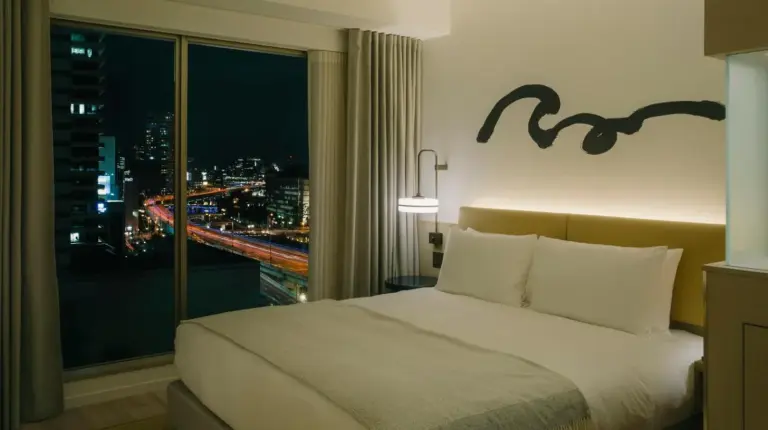 a hotel room with a bed and a window at Zentis Osaka in Osaka