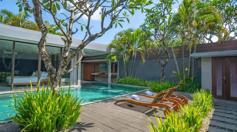 two chairs sitting next to a swimming pool at Ziva a Boutique Villa in Seminyak