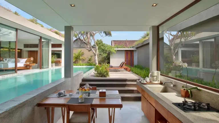 a bedroom with a bed and a large window at Ziva a Boutique Villa in Seminyak