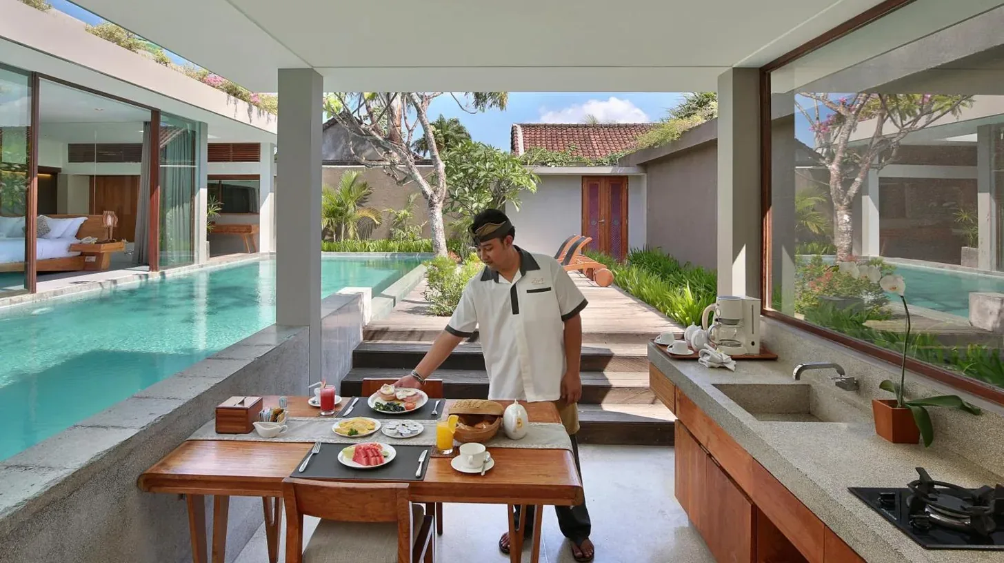 a living room with a tv and a couch and a table at Ziva a Boutique Villa in Seminyak